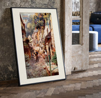Cobbled village street with boy and donkey print in a black frame leaning beside a vintage door on parquet