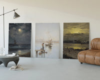 Coastal seascapes with sailing ships three-panel set displayed beside a brown leather sofa