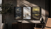Coastal seascapes with sailing ships triptych in three walnut frames above a sideboard in a warm room