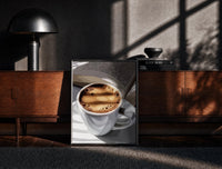 Black-framed Coffee and an Open Book print on the floor in front of a dark wooden console
