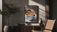 Coffee and an Open Book poster framed above a fluted sideboard beside a potted tree