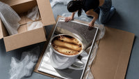 Coffee and an Open Book framed print being unpacked from protective bubble wrap and a box