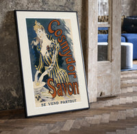 Woman washing hands in basin print in a black frame leaning beside a vintage door on parquet