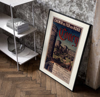 Medieval castle ruins with tower poster in a black frame leaning beside a shelf in a raw-plaster loft