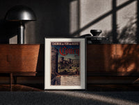 Black-framed medieval castle ruins with tower print on a moody console with designer coffee-table books