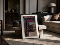 Medieval castle ruins with tower print in a black frame leaning on a travertine table in a sunlit lounge
