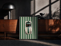 Black-framed 911 Targa Racing Stripes print on the floor in front of a dark wooden console