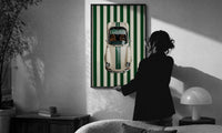 911 Targa Racing Stripes print in a slim black frame being hung on a sunlit wall in a monochrome room