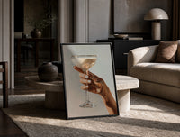 Cream Coupe Cocktail print on the floor, leaning against a travertine table