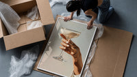 Cream Coupe Cocktail framed print being unpacked from protective bubble wrap and a box