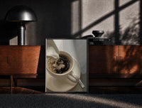 Black-framed Cream Poured into Black Coffee print on the floor in front of a dark wooden console