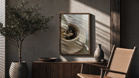 Cream Poured into Black Coffee poster framed above a fluted sideboard beside a potted tree