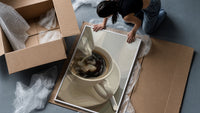 Cream Poured into Black Coffee framed print being unpacked from protective bubble wrap and a box
