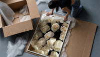 Cream Rose Bouquet framed print being unpacked from protective bubble wrap and a box