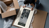 Perfume bottle on pedestal framed print being unpacked from protective bubble wrap and a box
