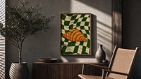 Croissant on Green Checkerboard poster framed above a fluted sideboard beside a potted tree