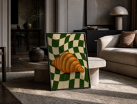 Croissant on Green Checkerboard print on the floor, leaning against a travertine table