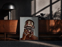 Black-framed Dangling Jewelry Over the Face print on the floor in front of a dark wooden console