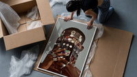 Dangling Jewelry Over the Face framed print being unpacked from protective bubble wrap and a box