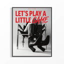 Dark-framed Let's Play a Little Game fashion poster on white wall — bold red text over B&W woman in black croc thigh-high boots seated on chrome chair