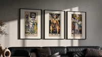 Three 1909 tarot cards triptych in three black frames on a grey wall above a leather sofa