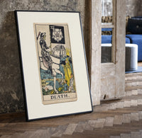 Skeleton knight riding white horse print in a black frame leaning beside a vintage door on parquet