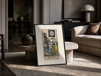 Skeleton knight riding white horse print in a black frame leaning on a travertine table in a sunlit lounge