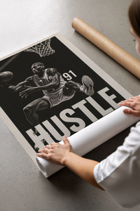 Woman lifting a Dennis Rodman basketball poster from a protective brown cardboard tube