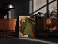 Black-framed Discipline Today Freedom Tomorrow print on the floor in front of a dark wooden console