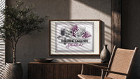 Woman smelling lilac flowers print in a wood frame above a fluted sideboard beside an olive tree