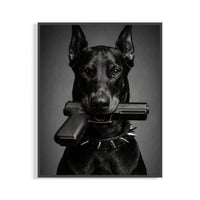Black and white framed art of a fierce Doberman gripping a pistol in its jaws with a spiked collar