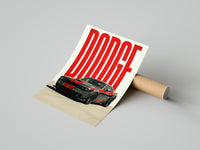 Person unrolling a Dodge Challenger SRT art print with red stripes on a smooth concrete floor