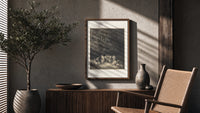 Gathering of robed classical poets poster framed above a fluted sideboard beside an olive tree