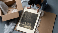 Gathering of robed classical poets framed print being unpacked from protective bubble wrap and a box