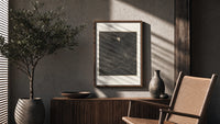 Man facing lion in dark forest poster framed above a fluted sideboard beside an olive tree