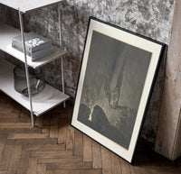 Two robed figures on cliff ledge poster in a black frame leaning beside a shelf in a raw-plaster loft