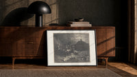 Centaurs shooting arrows at damned souls print in a black frame leaning against a walnut console in lamplight