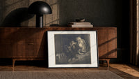 Crowned giant with serpent coiled print in a black frame leaning against a walnut console in lamplight