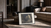 Crowned giant with serpent coiled print in a slim black frame leaning on a travertine coffee table