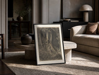 Robed man in dark forest print in a black frame leaning on a travertine table in a sunlit lounge