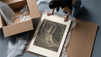 Robed man in dark forest framed print being unpacked from protective bubble wrap and a box