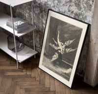 winged demon carrying nude figure poster in a black frame leaning beside a shelf in a raw-plaster loft