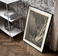 Two figures walking through dark forest poster in a black frame leaning beside a shelf in a raw-plaster loft