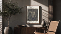Winged monster carrying two figures poster framed above a fluted sideboard beside an olive tree