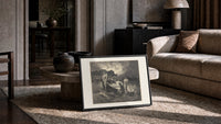 Boatman ferrying souls across river print in a slim black frame leaning on a travertine coffee table
