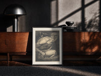 Black-framed Chained muscular giant with crown print on a moody console with designer coffee-table books