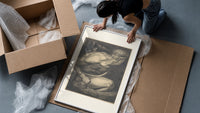 Chained muscular giant with crown framed print being unpacked from protective bubble wrap and a box