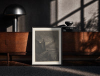 Black-framed Souls swirling in whirlwind before figures print on a moody console with designer coffee-table books