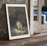 Glowing woman and robed figure print in a black frame leaning beside a vintage door on parquet