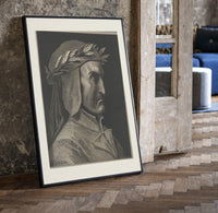Man wearing laurel wreath in profile print in a black frame leaning beside a vintage door on parquet